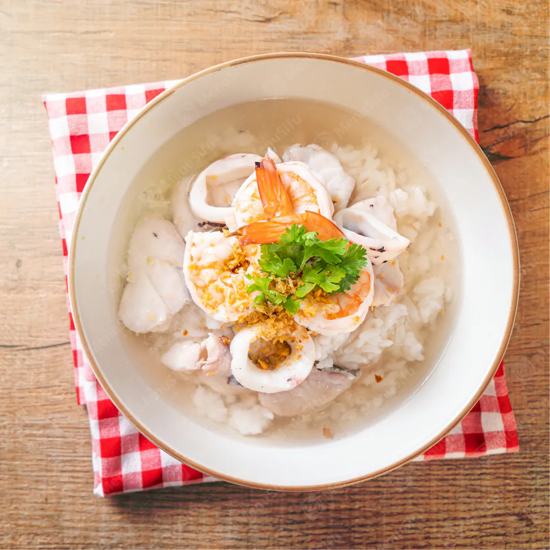 Seafood Rice Soup is a nourishing dish featuring a rice - based soup with fresh seafood like shrimp and squid at Queen Bakery II, a Chinese restaurant in NY